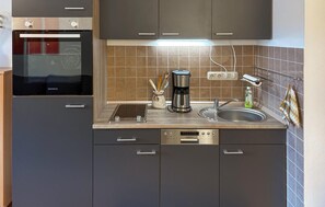 Fridge, stovetop, dishwasher, coffee/tea maker