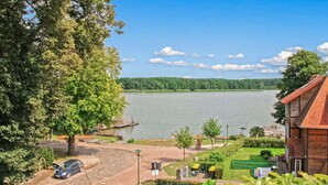 A lakeside property with a paved driveway, a dock, and a grassy area with a clothesline. - Beautiful apartment in Lychen with WiFi (Lychen)