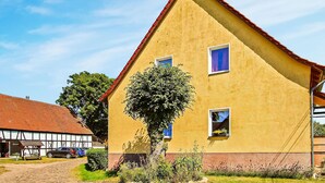 A yellow building with a red roof, two windows, and a tree in front. - Stunning apartment in Kieve with WiFi (Kieve)