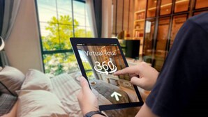 A person holding a tablet with a virtual tour interface, indicating a 360-degree view feature. - Luxury Treehouse in Blue Ridge, 2 bedrooms w/king beds, hot tub. Pet Friendly! (Morganton)