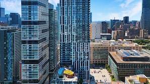 A high-rise urban area with modern skyscrapers, a central plaza, and a distinctive yellow-roofed building. - Panorama Suites (Toronto)