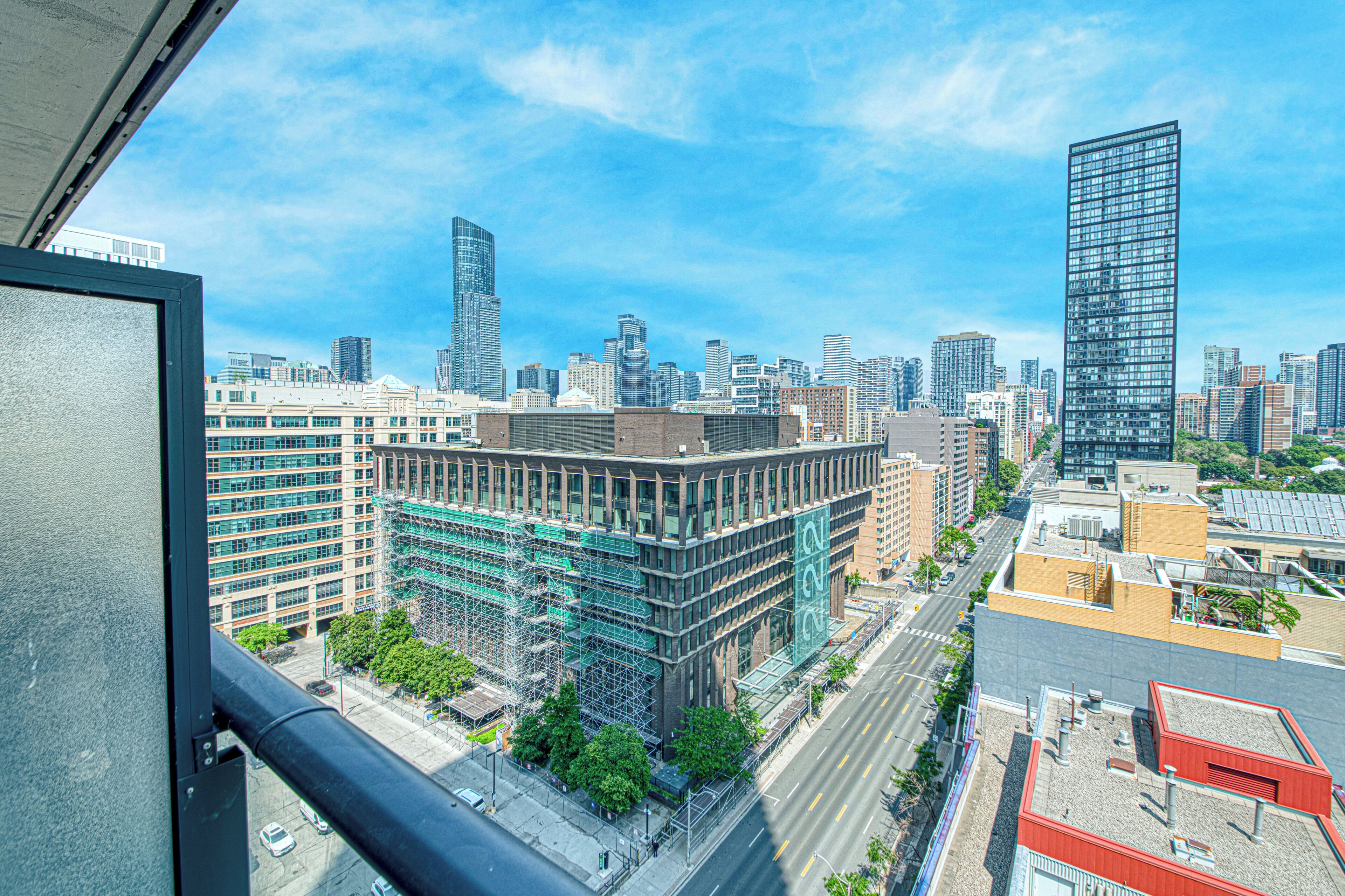 A cityscape with modern buildings, including a prominent skyscraper.