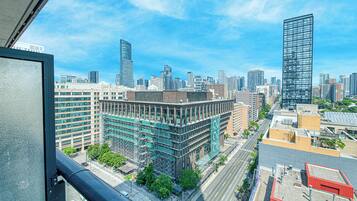A cityscape with modern buildings, including a prominent skyscraper.