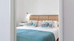 A bedroom with a bed, pillows, and a bedside table. -  'Alma Ocean View' with Sea View, Shared Pool and Wi-Fi (Puerto del Carmen)