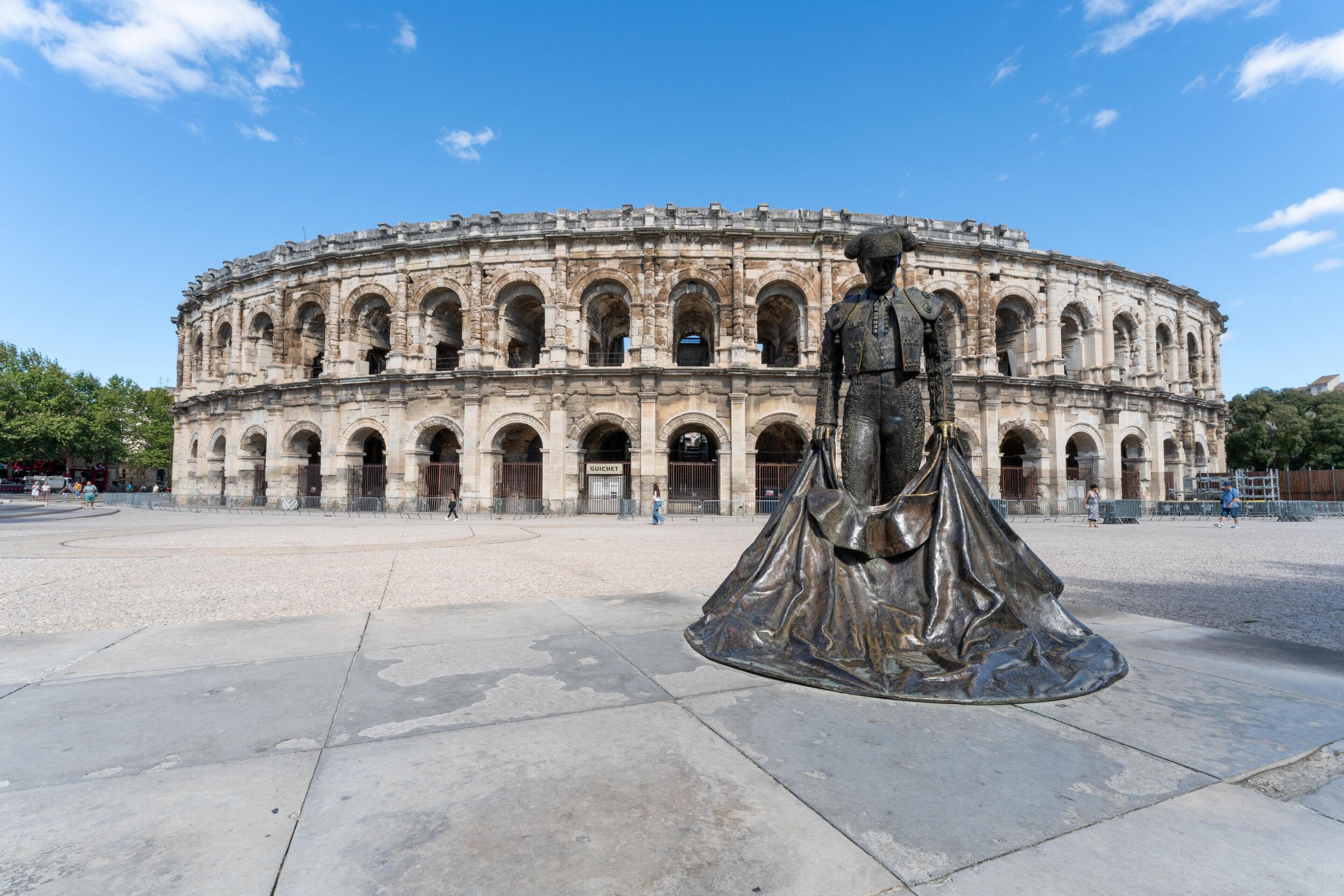 A historical building with a central statue.