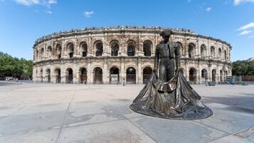 A historical building with a central statue.
