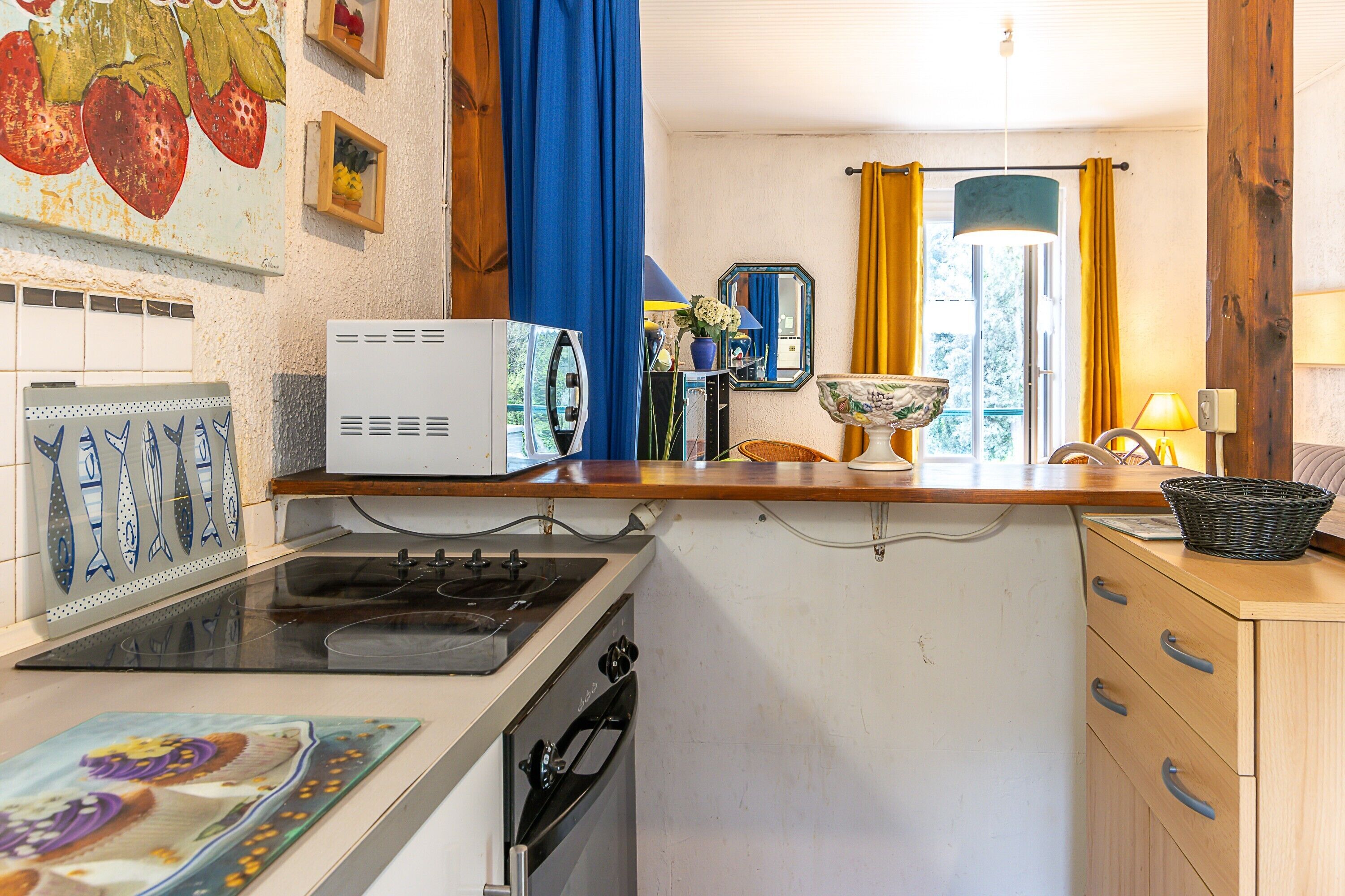 A compact kitchen with a stove, sink, and a small countertop.
