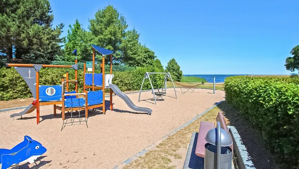 A playground with a slide, swings, and a climbing structure.