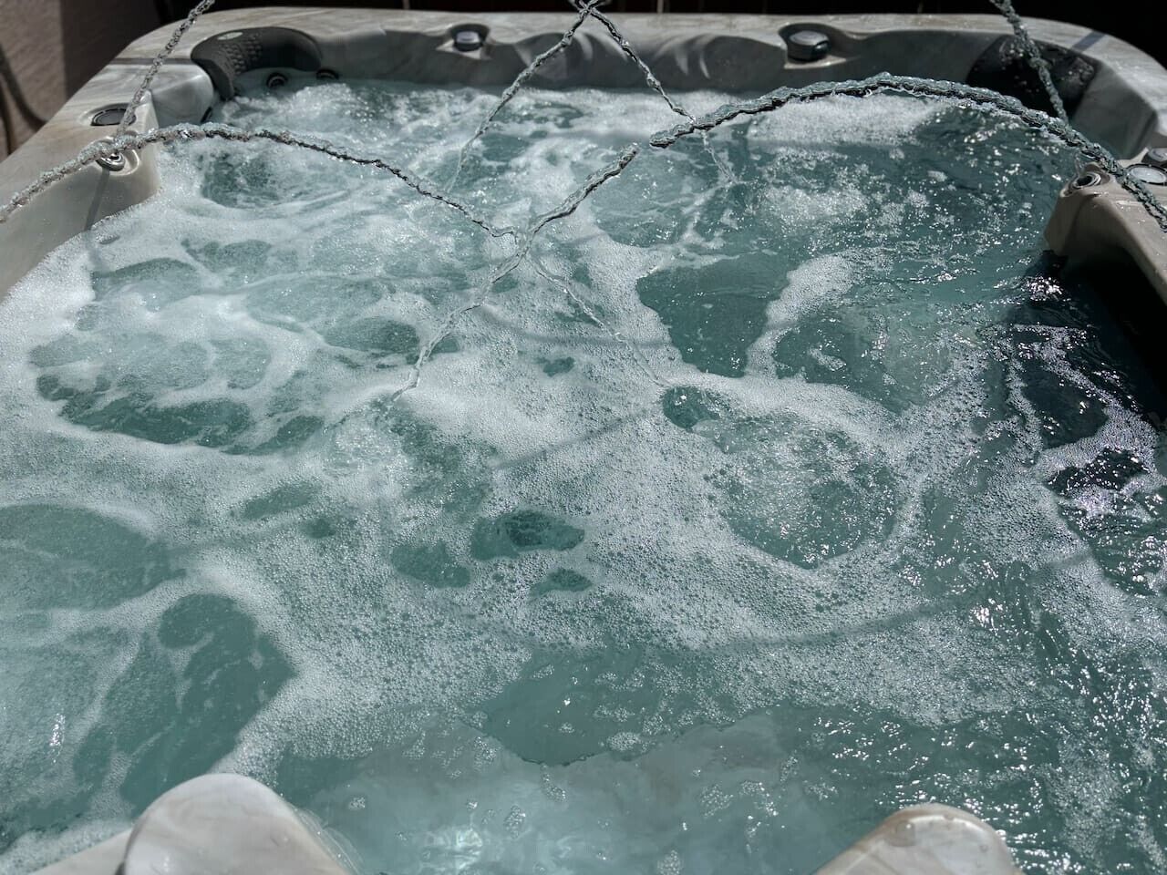 A hot tub with visible bubbles and a chain barrier.
