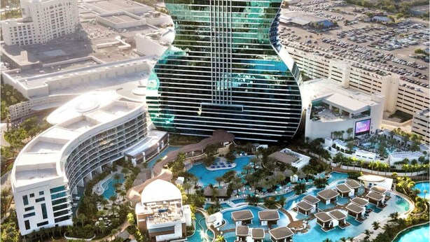 Um hotel moderno com um design único em formato de guitarra, várias piscinas e paisagismo exuberante.