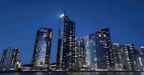 Experience the vibrant city skyline with stunning views of high-rise buildings and a majestic waterfront setting.