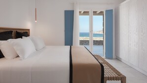 A bedroom with a large bed, a view of the sea, and a balcony. - Retreat Hill Luxury Villas Mykonos (Mykonos)