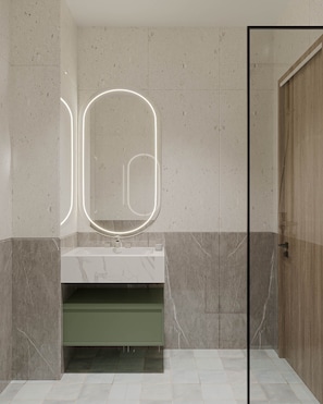 A modern bathroom with a marble sink, a glass-enclosed shower, and a wooden door.