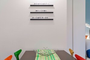 A modern interior with a table, chairs, and a decorative metal structure.