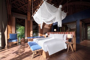A bedroom with a bed, bedside tables, a chair, and a hanging canopy. - Garrya Mu Cang Chai (Mu Cang Chai)