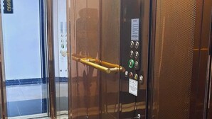 An elevator interior with metallic walls, a control panel with buttons, and a handrail. - Grand Royal Hotel (Silivri)