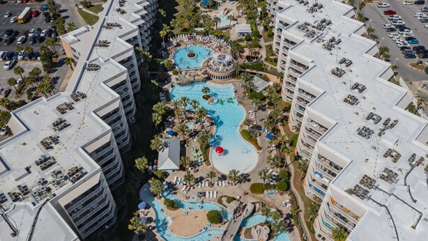 An aerial view of a hotel with multiple swimming pools, a central circular pool, and a beach area. - Waterscape A533 2Bed 2.5 Bath w Beach Service (Fort Walton Beach)