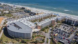 An aerial view of a coastal hotel with multiple buildings, a parking lot, and a beach. - Waterscape A533 2Bed 2.5 Bath w Beach Service (Fort Walton Beach)