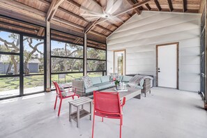 A spacious room with a high ceiling, large windows, a sofa set, and a dining area. - Cape Town 6031rpg 11 Bedroom Home by RedAwning (Rockport)