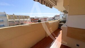A balcony with a tiled floor, a beige wall, and a view of other buildings. - T2, 2ème sans ascenseur, garage, crique de Lanau (Sète)