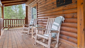 A wooden cabin with a porch, log walls, and a welcome sign. - New! Great Location, Game Room, Hot Tub, King Beds (Sevierville)