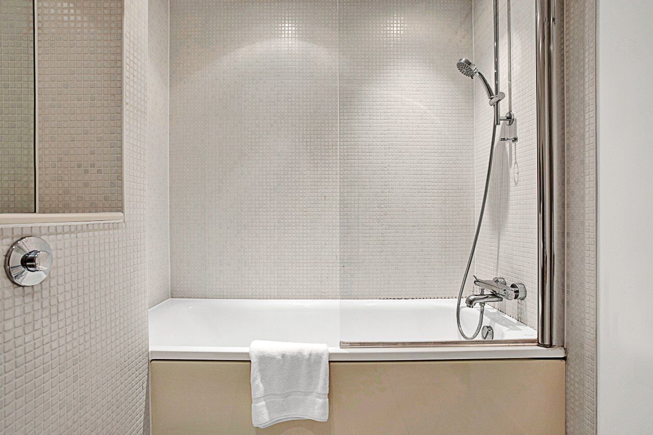 A bathroom with a bathtub, a shower, and a toilet.