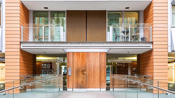 A modern building with a wooden facade and a balcony with glass railings. - Perfect Paddington Pad (London)