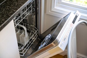 A dishwasher with a control panel and a white basket inside. - Fantastic Earls Court Flat (London)