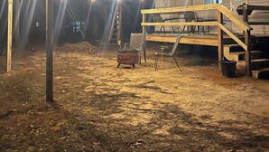 A campsite with a wooden deck, a metal pot, and a ladder. - Cozy little camper, nestled quietly in the country / only minutes from the city  (Purvis)