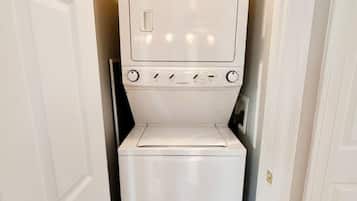 A compact laundry room with a washing machine and dryer stacked vertically.