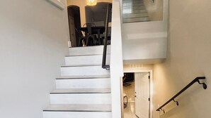 A staircase with white steps leading to a second floor. - Best 3-Story Home in Vegas - 9mins to Everything! (Las Vegas)