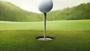 A golf ball on a tee in a hole on a green field.