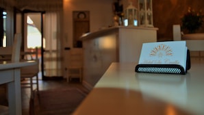 A hotel reception desk with a sign reading "Hotel San Cristobal."