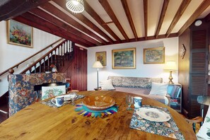 Enjoy meals in this inviting dining area with a beautifully set table and comfortable seating.