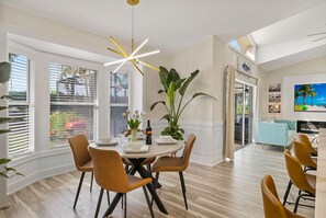 Enjoy meals with family and friends in this stylish dining area, featuring a round table and comfortable seating for four.