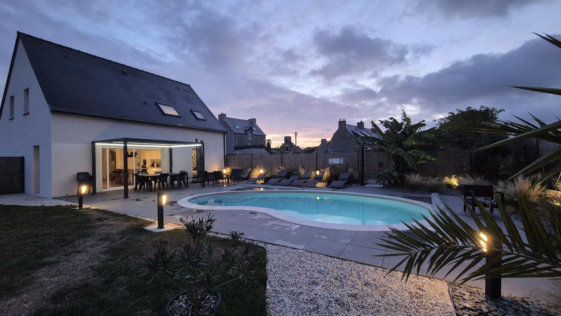 A swimming pool with lounge chairs and a covered patio area.