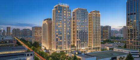 A high-rise hotel with multiple floors, a well-lit facade, and a modern architectural design.
