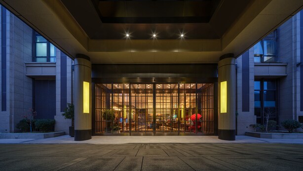A modern hotel entrance with a glass facade, large columns, and a well-lit interior. - UrCove by Hyatt Xi'an Hi-Tech CROSS Wanxianghui (Xi'an)