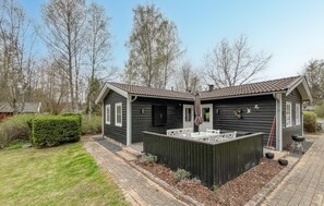 A two-story wooden house with a fenced patio area. - 3 bedroom beautiful home in Hörby (Hörby)