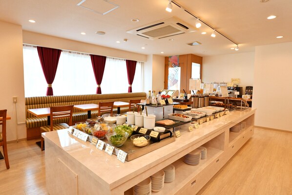 A buffet area with various food stations, seating arrangements, and a coffee bar. - Smile Hotel Kushiro (Kushiro)