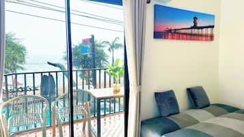 Deluxe Room, Balcony, Sea View | Minibar, in-room safe, desk, free WiFi