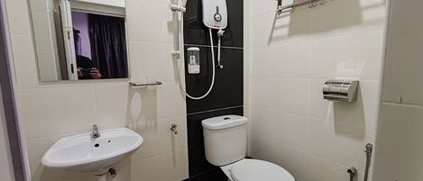 A bathroom with a sink, toilet, and shower.