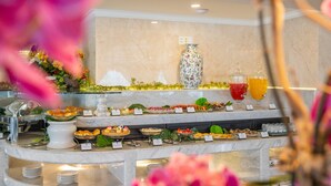 Un bufé con diferentes opciones de comida y un jarrón decorativo.