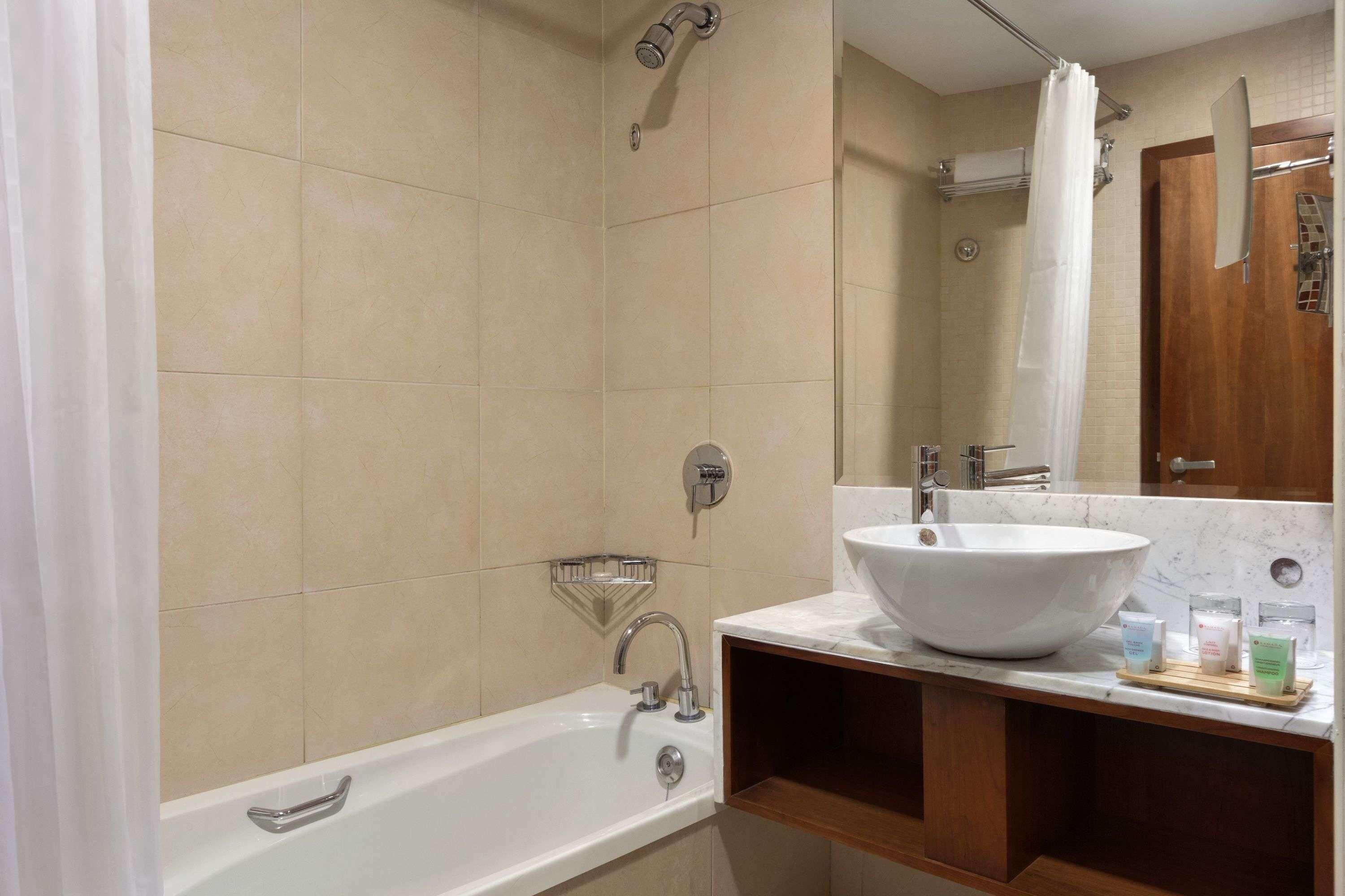 A bathroom with a bathtub, a sink, and a shower.