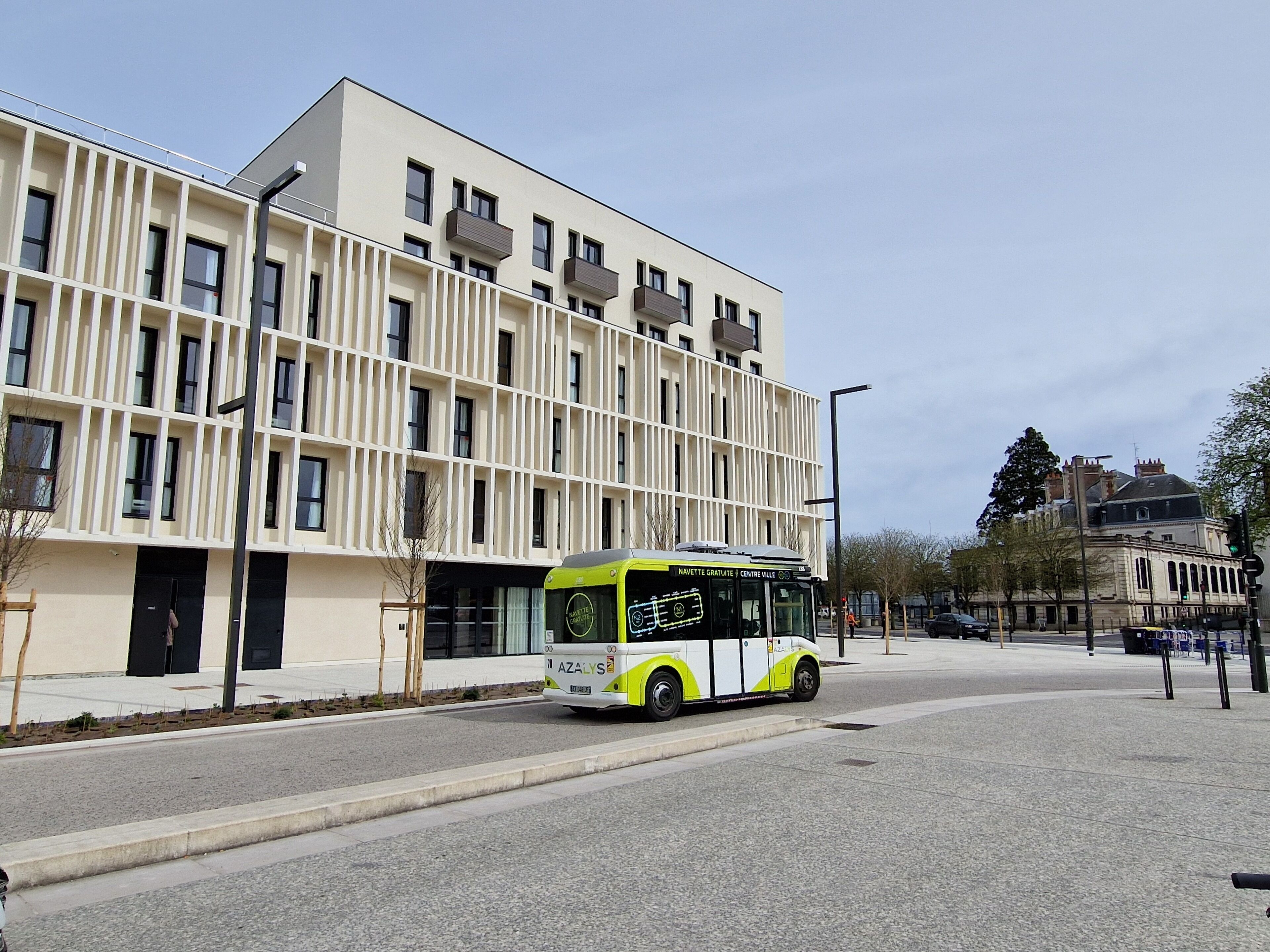 A modern building with a flat facade and large windows.