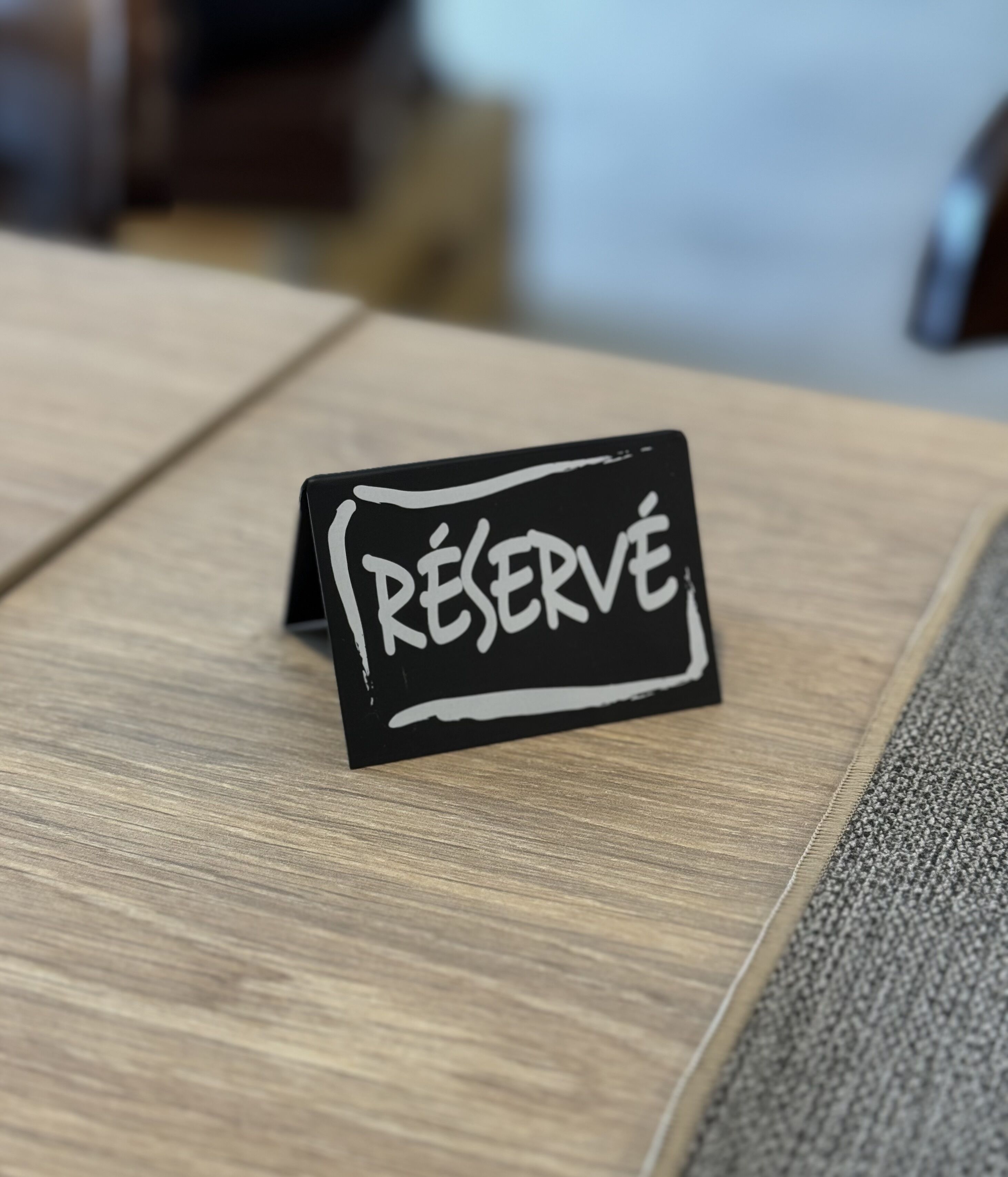 A black sign with the word "RESERVE" written on it.
