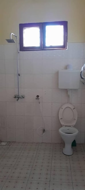Habitación estándar doble | Baño | Ducha, cabezal de ducha tipo lluvia, zapatillas y bidé