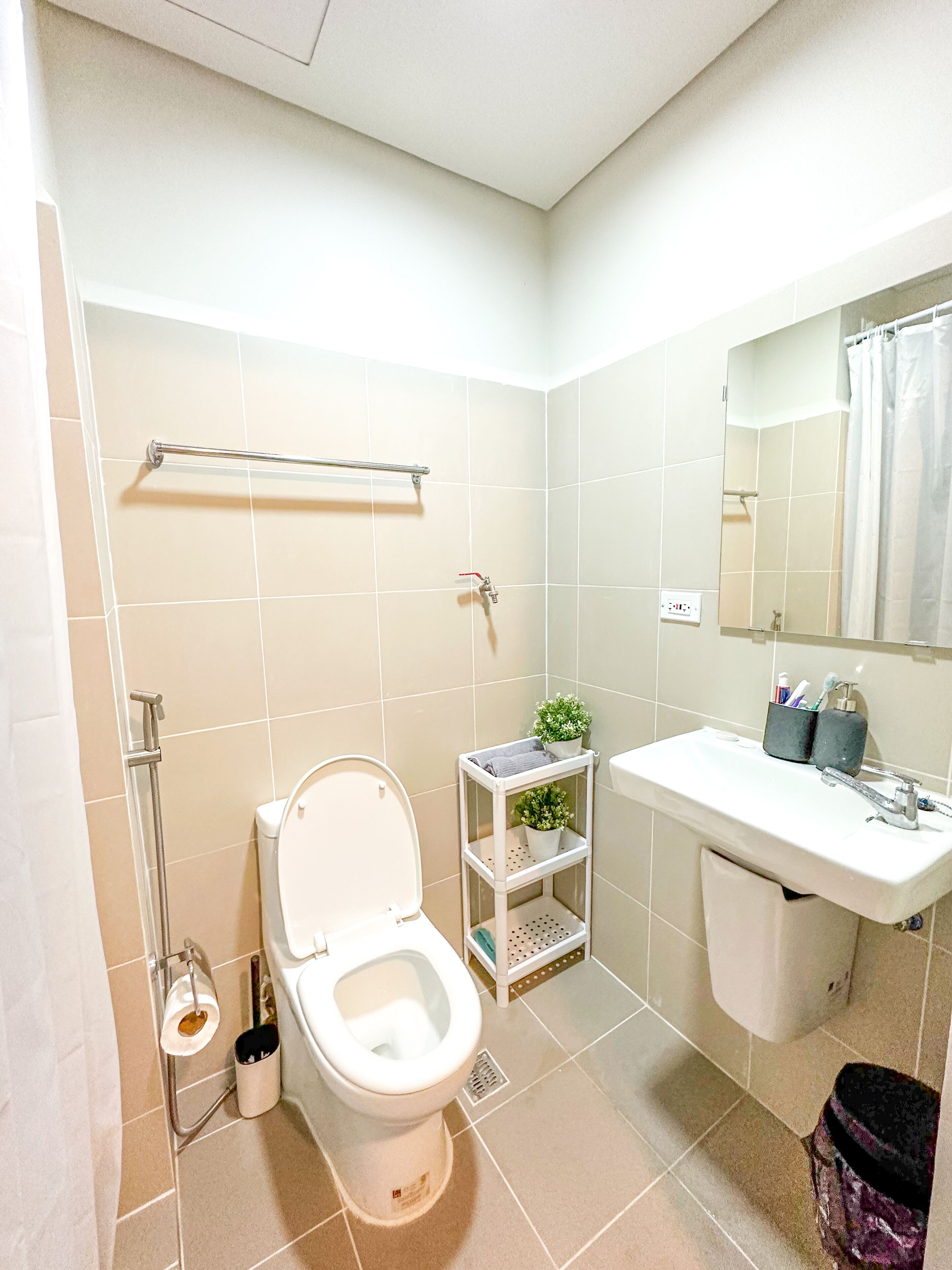 A modern bathroom with a toilet, sink, and shower.