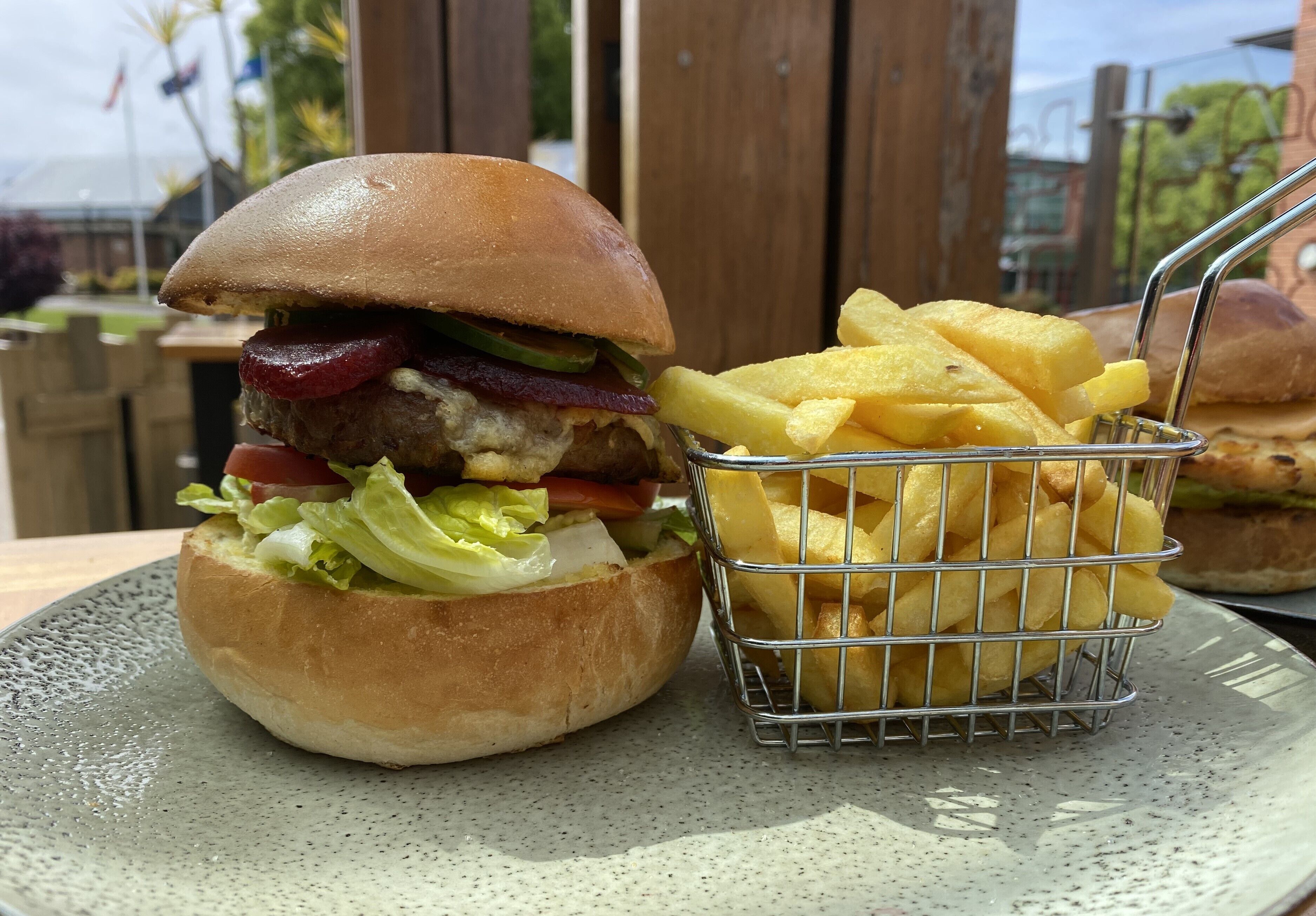 A burger with fries on a plate.