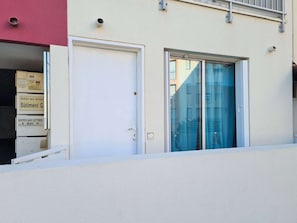 Stunning building facade with two entrance doors and a window, offering a glimpse into the interior.